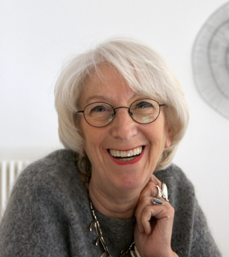 Portrait d’Izya Barrett, une femme souriante, dans un cadre apaisant, évoquant l’écoute et l’accompagnement relationnel