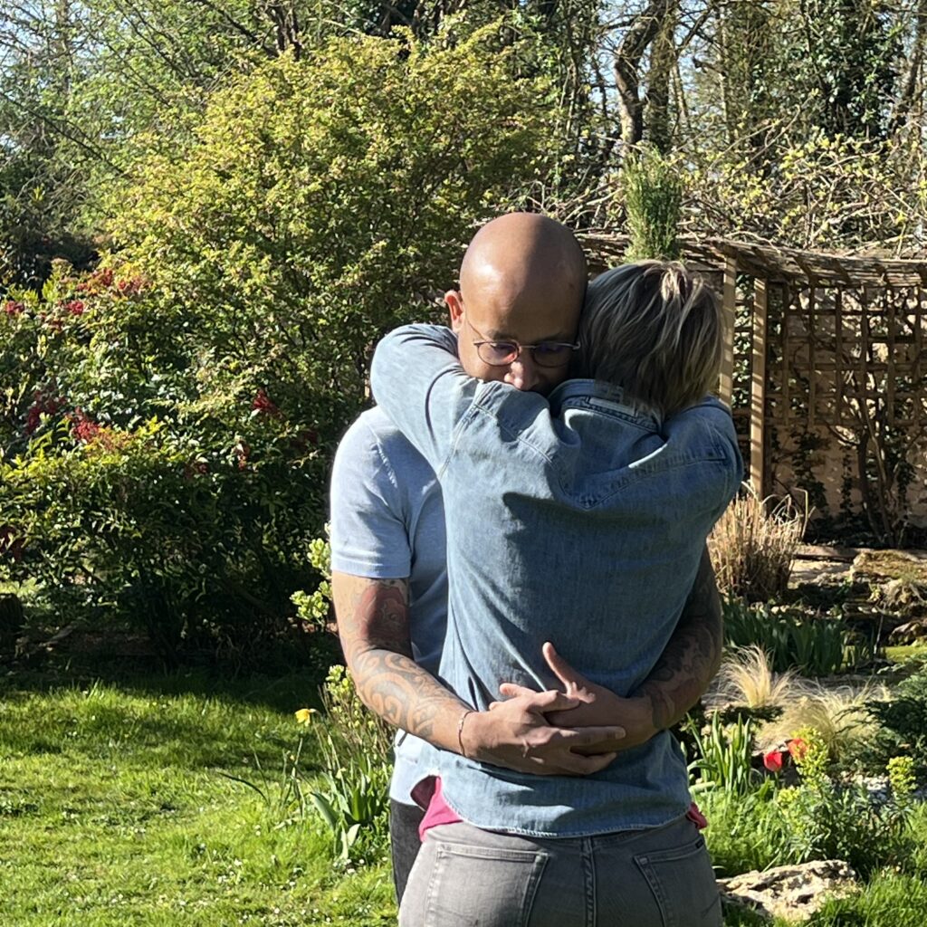 Couple enlacé dans un jardin verdoyant lors d’un week-end en amoureux